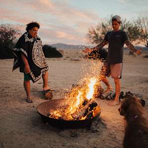 people campfire dog