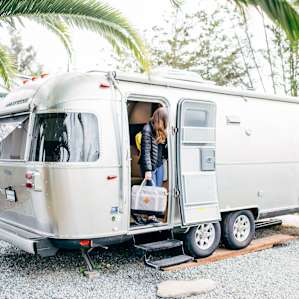The Cloud Trailer sits on it's own landing, nestled between greenery and a detached garage.