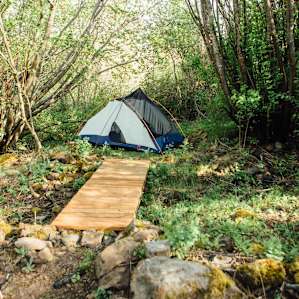 The quarry campsite is secluded and surrounded by lush vegetation.