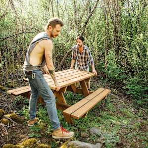 The Hosts, Steven and Derrick moving their freshly made picnic table up to The Quarry campsite.