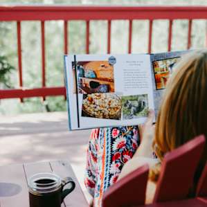My friend reviewing the nice welcome book that was left near the snack basket