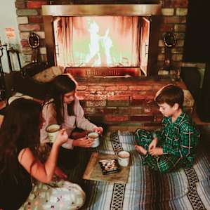 The kiddos enjoying some hot cocoa and treats by the fire