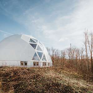 This geodesic dome with a passive solar design serves as the future home of a kitchen and bathroom. It's the community gathering space.