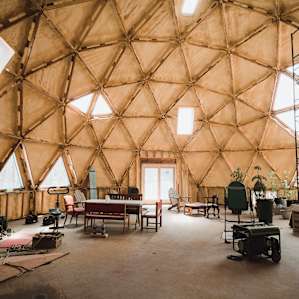 The geodesic dome (with a passive solar design) serves as the community gathering area. It is the future home of a shared kitchen and bathroom.