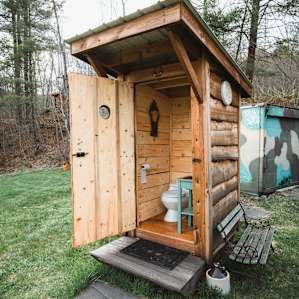 The lower level of the property has a gorgeous bathroom. You simply can't call this an outhouse.