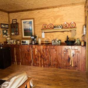Finished kitchenette inside the cabin, with all sorts of country charm.