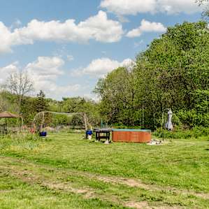 This open community area holds a hot tub, several seating areas, as well as a community fire pit.