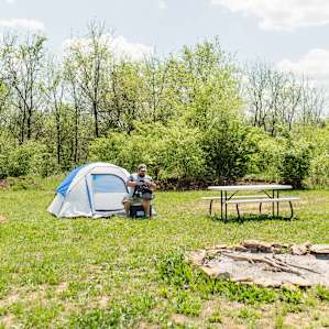 There is a picnic table and a huge fire pit available.