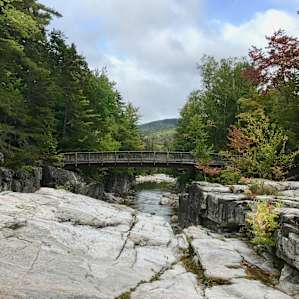 Rocky Gorge located 5 miles east of Passaconaway on the Kancamagus Highway. Very scenic. Great hiking trail for old pups.