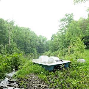 A little paddleboat waiting for you at the pond.