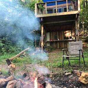 Making a fire in front of the treehouse