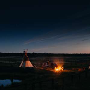 Enjoying a campfire at night outside the tipi.