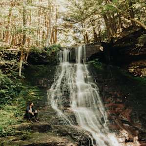 Sitting alongside the waterfall admiring it's beauty. A peaceful spot to read, write or just stare off into space.