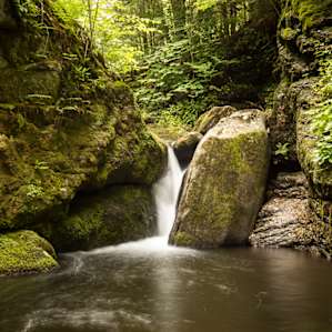Waterfall pouring into the main swimming hole.