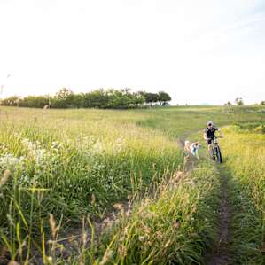 Pedaling past a small pond next door as we made our way to the main trail network.