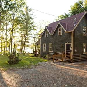 Late-evening sun illuminates the back of the cabin.