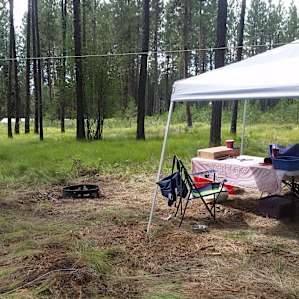 Brought our own canopy and table. Not completely flay ground, but still a comfortable area for eating and socializing.