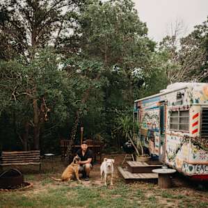 Enjoying time with some of the dogs on the property! Outside the trailer there is a sitting area and firepit for your use as well.