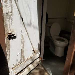 The restroom huts are rustic and really need new doors for better privacy.