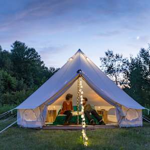 There is nothing more magical than a tent at twilight. The bell tent is set up with pretty string lights on the posts and down the front, as well as a lantern hanging from inside the top, so even after dark the tent was an inviting place to hang out.
