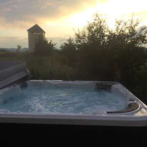 Large hot tub surrounded by beautiful landscaping, orchard keeps views from spa to campsites private
