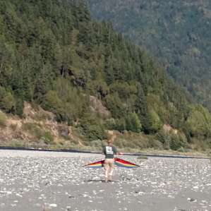The river bank was a perfect place to fly the kite in the afternoon.