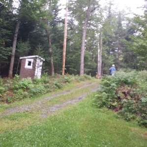The access drive and pit toilet. The campsite is located just at the top to the left.