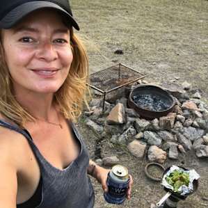 Cooking dinner at the fire ring provided. There are stacks of firewood provided and buckets of non-potable water nearby to extinguish your night's fire.