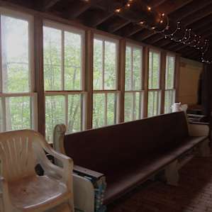 Looking out the left side of the pavilion. Looking out you see woods down the hill, then main driveway, then pond, then main house.