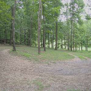 Photo taken from pavilion. This is the circle drive at the top of the hill you drive up to get to campsite area. You drive down main driveway and then see a "Hipcamp" sign on the left directing you up the hill on the left, that curves left into this circle
