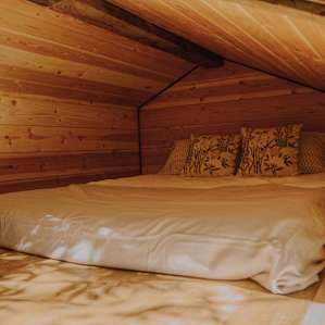 A view of the loft and shadows from the large skylight above the bed area. You can see stars in the clear sky at night.
