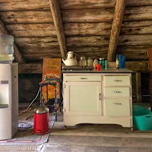 The loft has everything you need for the perfect glamping trip: a mini fridge, water, cups, plates, silverware, a two-burner hot plate, coffee and tea, and more!