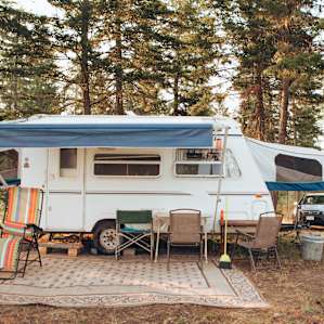 Adorable camper with a nice patio area.