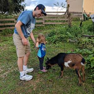 Paul and kiddo getting to know one of the goats - a friendly unicorn 😉