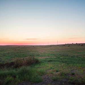 Sunset over the field across the street