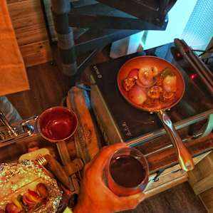 Making our vegan dinner for the night with a glass of wine!
