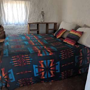 Inside the air conditioned room. It's a queen bed and a shelf on the far side for clothes or whatever else you'd want to unpack.