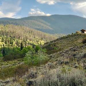 View of the cabin while hiking below. There are a bunch of cow trails on public land you can explore.