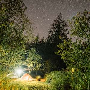 A few stars over a tent area.