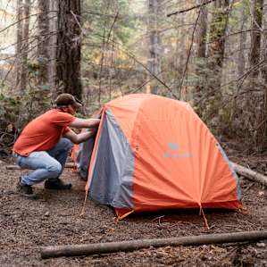 Size comparison. They have several sites to set up your tent in. This is a 2 person backpacking tent. Guy in red shirt is over 6' 3''. Plenty of space all around.