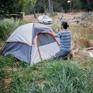 Putting final touches on my tent. Also notice how close you can park your car, for added security.