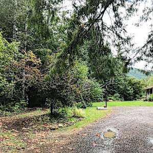 Entry into Tranquil Acres. The hill going down to the campsites and river are on the the left and host's home is on the right.