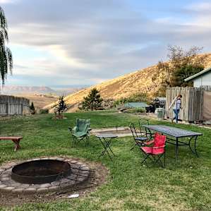 The campsite from our tent location, with fire pit, horseshoes, grill, toilet/sink/shower area to the right, and the view out over the valley beyond.