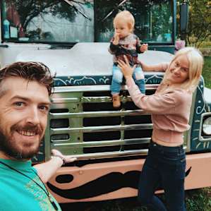 My husband with our daughter in front of one of the cool buses, which are located on the property.