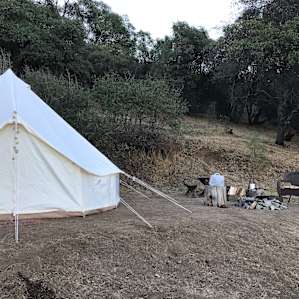 tent with fire pit and seating right beside
