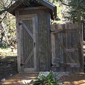 Hand-built privy equipped with a shower and composting toilet