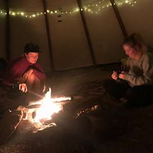 Getting campfire going for making dinner in the tipi.