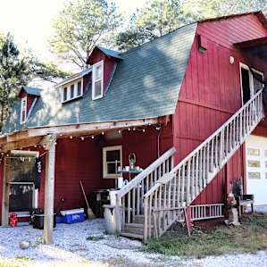 Charming barn with access to bathroom and covered cooking area.