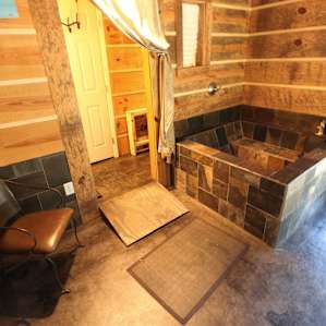 The lovely bathroom with tub/shower and private sink/toilet area.