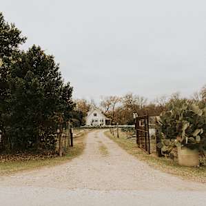 The entrance to the farm. This is opposite of where the parking lot for regular customers is located. The driveway crosses a small drainage and your parking is on the right.
